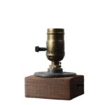 Vintage-style microscope with brass and wooden base, ideal for science education and decor. Perfect for science enthusiasts and educational settings.