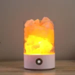 Himalayan salt lamp with a misting feature, emitting a warm glow and creating a calming atmosphere, perfect for home decor and relaxation.