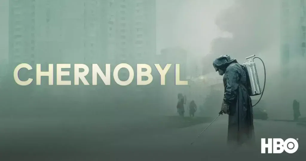 A firefighter in protective gear spraying water amidst a smoky, devastated Chernobyl landscape with ruined buildings and a hazy sky.