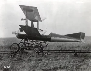 Rocket-powered aircraft on a grassy field, vintage black and white photograph.