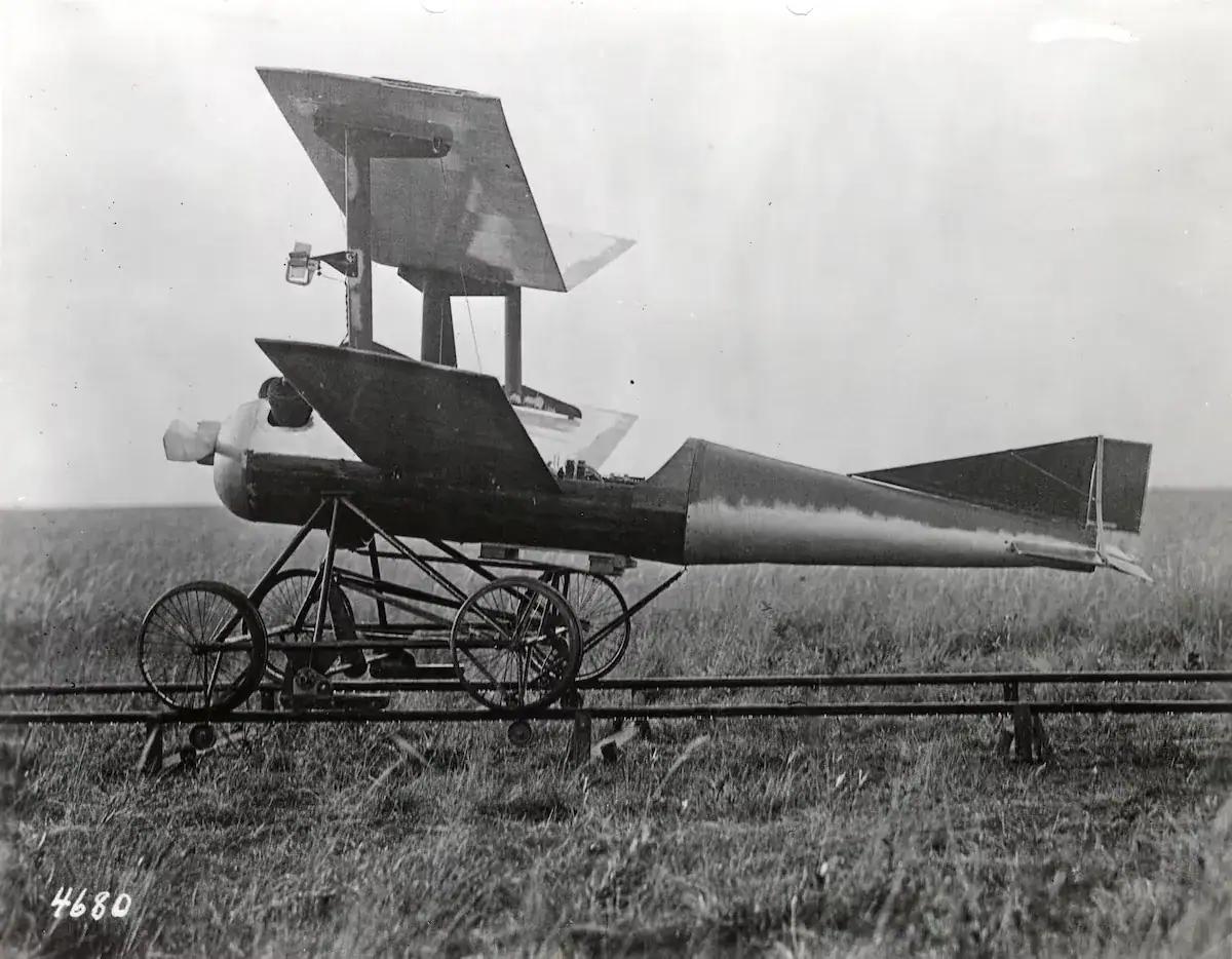Rocket-powered aircraft on a grassy field, vintage black and white photograph.