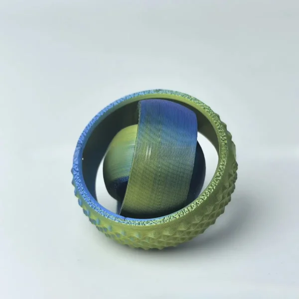 Close-up of a tennis ball with an innovative internal design, showcasing a layered, colorful core inside a textured green outer shell.