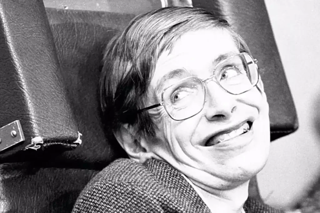 Vintage black and white photo of a smiling man with glasses, sitting in a chair, showcasing a humorous expression.