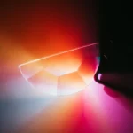 Close-up of a prism dispersing light into a spectrum of vibrant colors, creating a stunning visual display of light refraction and dispersion.