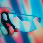Brightly colored kaleidoscope with a black handle, showcasing vibrant, shifting patterns.