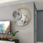 Unique space-themed wall clock with astronaut figurine and moon design, perfect for science enthusiasts and educational decor.