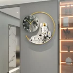 Modern wall clock featuring an astronaut figurine on a lunar surface with a moon phase background, perfect for space-themed decor.