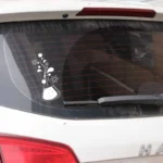 Beaker with bubbling chemical reaction sticker on car rear window, science-themed decal for decoration or educational purposes.