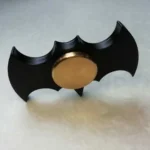 Bat-shaped fidget spinner with a metallic gold center, designed for stress relief and focus enhancement. Compact and lightweight, perfect for educational and sensory activities.