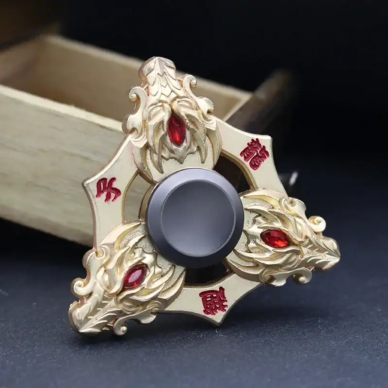 Fidget Spinner with Dragon Design Decorative dragon-themed fidget spinner with intricate gold detailing and red gemstone accents, designed for stress relief and sensory stimulation.