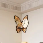 Unique butterfly-shaped wall clock featuring floral accents and a modern design, perfect for home decor and adding a whimsical touch to any room.