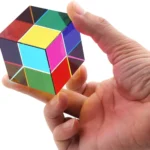 Hand holding a colorful Rubik's Cube, showcasing its vibrant squares and intricate design.