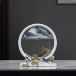 A decorative water fountain with a circular mirror and metallic animal figurines on a sleek surface.