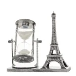 Elegant hourglass with white sand and a detailed miniature Eiffel Tower for educational and decorative purposes. Perfect for science enthusiasts and home or office decor.