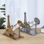 Decorative Eiffel Tower-inspired hourglass with metallic finish, perfect for science-themed decor or educational displays.