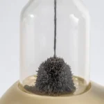 Close-up of black ferrofluid reacting to a magnetic field inside a glass dome, demonstrating magnetic fluid properties for educational science experiments.