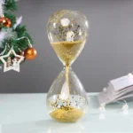 Elegant hourglass with gold glitter particles, perfect for home decor or educational purposes, showcasing a modern twist on classic timekeeping.