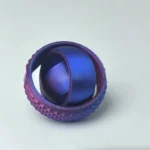 A 3D-printed geometric sphere with textured and smooth surfaces, showcasing intricate design and vibrant colors, perfect for educational and decorative purposes.
