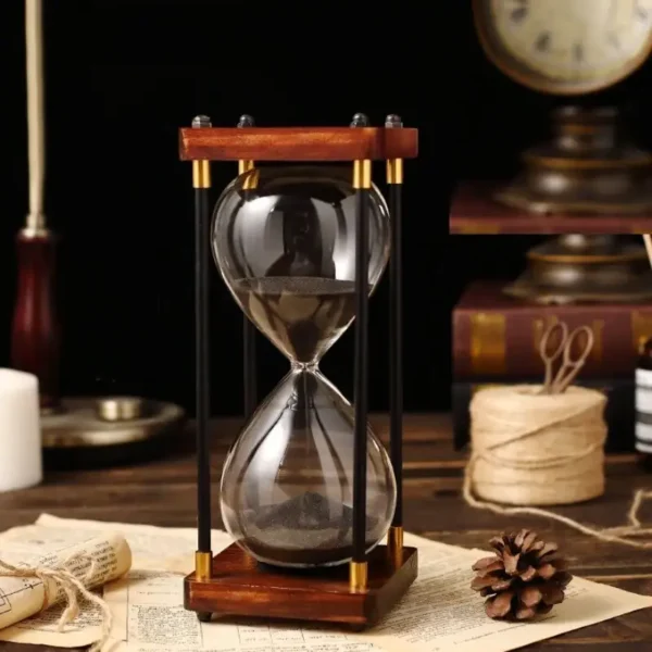 Elegant sand timer with wooden frame and black sand, perfect for science decor and educational displays.
