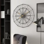 Stylish geometric wall clock with black wireframe design and gold hands, perfect for contemporary home decor.