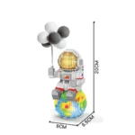 Small pixel art robot holding black and white balloons, standing on a colorful globe, measuring approximately 20cm tall, perfect for science decor and educational toys.