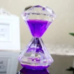 A clear hourglass-shaped science gadget filled with vibrant purple liquid, used for educational demonstrations and decorative purposes.