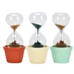 Brightly colored hourglass timers with black and brown sand, placed in vibrant pots for educational and decorative purposes.