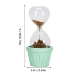 Small sand timer with brown sand in a mint green pot, perfect for science experiments and educational decor. Measures approximately 14.7 cm tall and 6.8 cm wide.