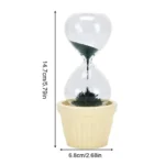 Clear hourglass with black sand flowing through the center, placed in a beige pot, measuring 14.7 cm tall and 6.8 cm wide, ideal for science decor and educational purposes.