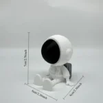 Cute astronaut figurine with a black visor, sitting on a plain background, perfect for science-themed decor and educational displays.