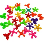 Assorted colorful plastic fidget spinner pieces in various shapes and colors, suitable for science decor and educational toy projects.