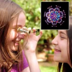 Children using a magnetic kaleidoscope outdoors, observing colorful patterns and light reflections, promoting educational fun and curiosity in science.