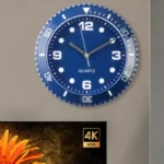 A stylish blue wall clock featuring white numerals and hands, perfect for modern interiors. It operates with quartz movement for accurate timekeeping and adds a contemporary touch to any space.