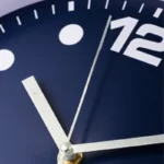 High-quality wall clock featuring a sleek blue dial, silver hour and minute hands, and a precise second hand, perfect for home or office decor.