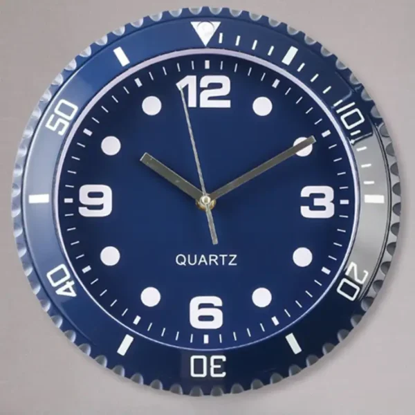 Quartz wall clock with a blue face, white numerals, and a silver bezel, featuring hour, minute, and second hands for precise timekeeping.