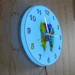 Bright blue wall clock with colorful paint splatter design, perfect for science-themed decor or educational settings.