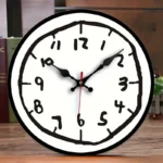 Stylish wall clock featuring a handwritten-style face with bold black numbers and hands, perfect for contemporary home or office decor.