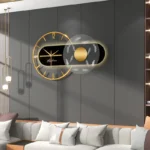 Stylish modern wall clock featuring a geometric black and gold design with LED accents, mounted on a sleek gray wall in a contemporary living room setting.