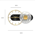 Stylish 36cm x 36cm modern wall clock featuring a gold frame, black and white geometric design, and minimalist aesthetic for contemporary home decor.