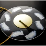 Elegant feather clock with Eiffel Tower reflection, black background, and gold accents, combining art and science for a stylish decor piece.