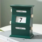 Vintage-style flip calendar clock displaying "Sunday, October 7" in a modern, educational science decor setting.