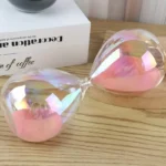 Elegant glass sand timer with pink sand, ideal for educational and decorative purposes, showcasing the passage of time in a stylish design.
