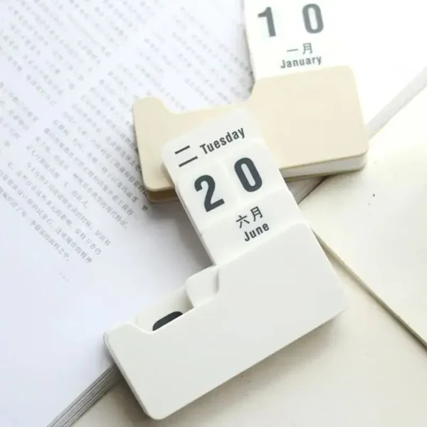 Close-up of a white calendar flip clock showing January 10, with a focus on the date display and the flip mechanism.