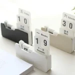 A modern perpetual desk calendar with rotating blocks displaying dates and days of the week, perfect for organizing schedules in a stylish way.