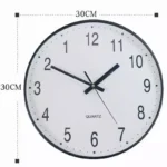 Round 30cm quartz wall clock with black frame and white face, featuring black numerals and hands, ideal for classroom, office, or home decor.