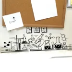 E=mc^2 equation note pinned on corkboard.