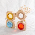 Wooden camera lens toys in yellow, blue, and red, designed for children’s educational play and home decor.