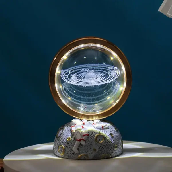 Decorative galaxy lamp featuring a miniature astronaut figure on a textured base, with a solar system design illuminated inside, perfect for science-themed decor and educational purposes.