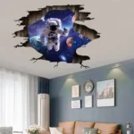 Space-themed astronaut wall mural creating an illusion of a hole in the ceiling revealing outer space with planets and stars. Perfect for science decor and educational settings.