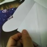 Handcrafting a paper airplane with precise folds for educational fun.